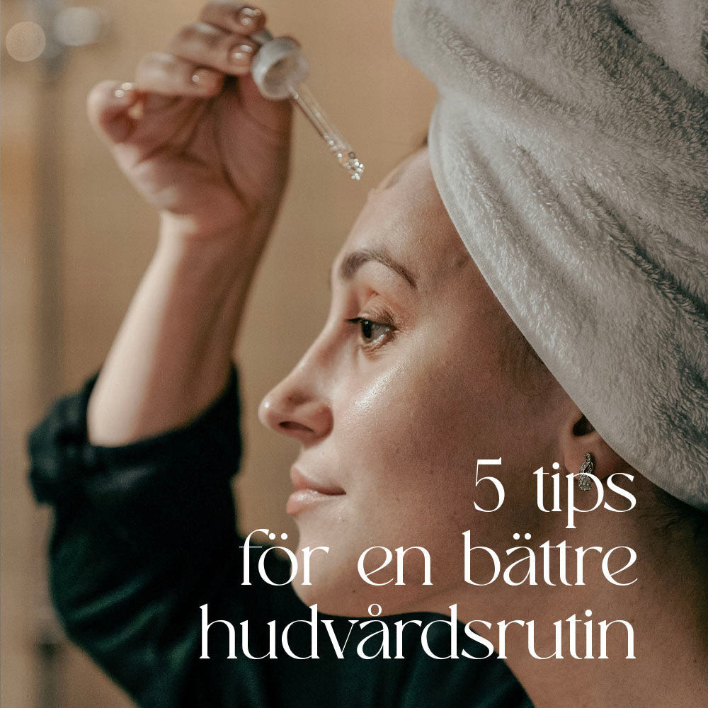 Kvinna droppar serum ur pipett på ansiktet